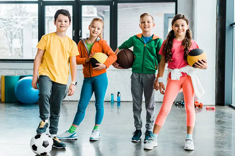 A group of athletic kids smiling