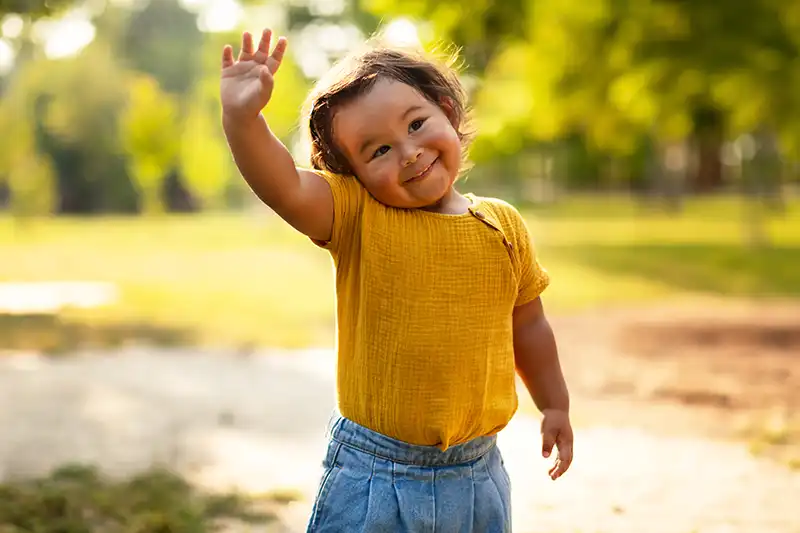 A kid saying Hi